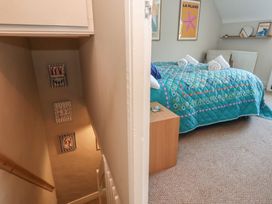 A bedroom with a staircase leading down at Mallow Cottage in Langton Matravers