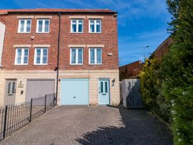 A house exterior with a brick wall and garage door at The Shipwrights in Whitby