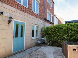 An outdoor area with a blue door and seating at The Shipwrights in Whitby