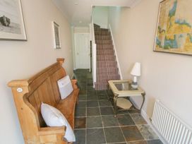 A hallway with a bench, lamp, and side table at The Shipwrights in Whitby