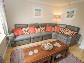 A living room with a corner sofa and a coffee table at The Shipwrights in Whitby