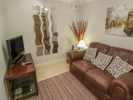 A living room with a sofa and television at The Shipwrights in Whitby