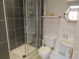 A bathroom with a shower, toilet, and sink at The Shipwrights in Whitby