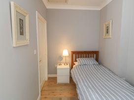A bedroom with a bed and lamp at The Shipwrights in Whitby