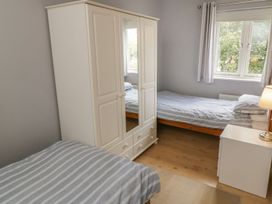 A bedroom with two beds and a wardrobe at The Shipwrights in Whitby