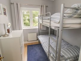 A bedroom with a bunk bed and a dressing table at The Shipwrights in Whitby