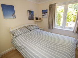 A bedroom with a bed and wall art at The Shipwrights in Whitby