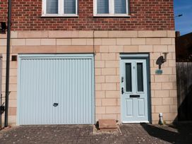 Exterior view of a house with a garage door and front door at The Shipwrights in Whitby