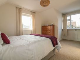 A bedroom with a bed and dresser at Chy Vean in St. Agnes