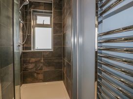A bathroom with a shower and towel radiator at Chy Vean in St. Agnes