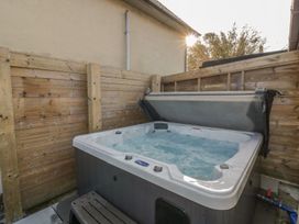 A hot tub surrounded by a wooden fence at Chy Vean St. Agnes