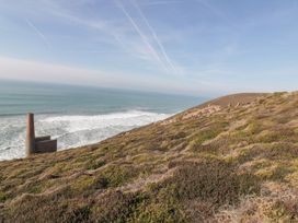 A coastal landscape with a chimney beside the ocean at Chy Vean in St. Agnes