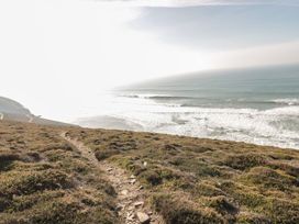 A coastal view with ocean waves and a path at Chy Vean in St. Agnes