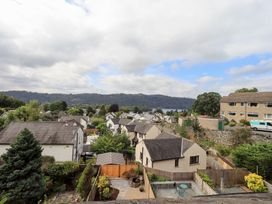 A view of houses and trees towards a lake and mountains at Stoker’s Cottage Bowness-On-Windermere