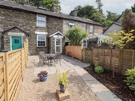 An outdoor area with a patio and table at Stoker’s Cottage in Bowness-On-Windermere