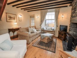 A living room with a sofa and television at Stoker’s Cottage in Bowness-On-Windermere
