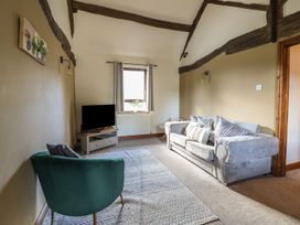 A living room with a sofa and television at Idris Barn Dolgellau