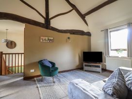 A living room with a sofa and television at Idris Barn in Dolgellau