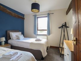 A bedroom with two beds and a window at Idris Barn in Dolgellau