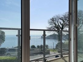 A view from a window showing a balcony overlooking the sea at 10 Croft Court in Tenby