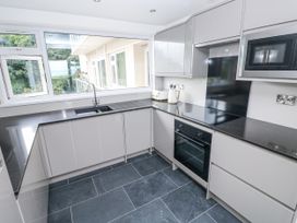 A kitchen with cabinets and appliances at Lifeboat Lookout in Tenby