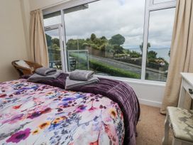 A bedroom with a bed and window view at Lifeboat Lookout in Tenby