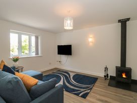 A living room with a sofa and television at 1 The Stables Highbridge