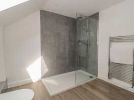 A bathroom with a shower and towel rack at 1 The Stables in Highbridge