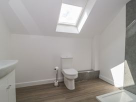 A bathroom with a toilet and sink at 1 The Stables, Highbridge