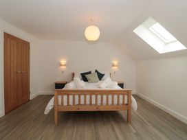 A bedroom with a bed and nightstand at 1 The Stables Highbridge