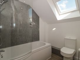 A bathroom with a bathtub and toilet at 1 The Stables in Highbridge