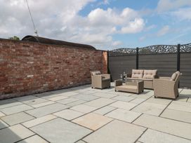 A patio with seating and a table at 1 The Stables Highbridge