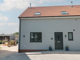 Front view of a house with a door and windows at 1 The Stables Highbridge