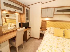 A bedroom with a bed and desk area at 22 Yealand in Carnforth