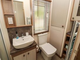 A bathroom with a sink and toilet at 22 Yealand in Carnforth