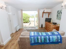 A living room with a sofa and television at Hafan Bach in Abersoch