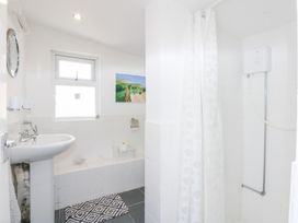 A bathroom with a sink and shower at Hafan Bach in Abersoch