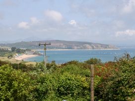 A view of beach and water with boats at Hafan Bach in Abersoch