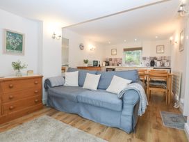 A living room with a sofa and dining area at Hafan Bach Bwlchtocyn near Abersoch