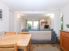 A living room with a sofa and dining area at Hafan Bach Bwlchtocyn near Abersoch