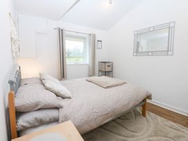 A bedroom with a bed and window at Hafan Bach Bwlchtocyn near Abersoch