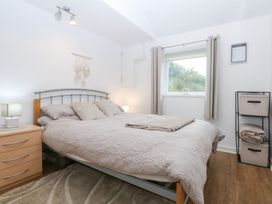 A bedroom with a bed and bedside table at Hafan Bach in Bwlchtocyn near Abersoch