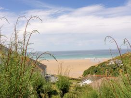 A view of the beach and sea with houses in the foreground at 8 Karn Havos in St. Eval near Mawgan Porth
