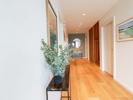 A hallway with a plant and mirror at 8 Karn Havos St. Eval near Mawgan Porth