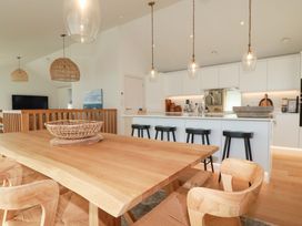 A dining room with a table and chairs at 8 Karn Havos in St. Eval near Mawgan Porth