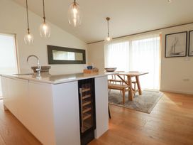 A kitchen with a dining table and chairs at 8 Karn Havos St. Eval near Mawgan Porth