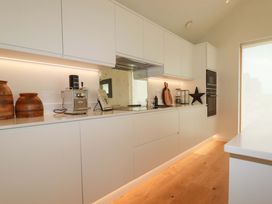 A kitchen with cabinets and appliances at 8 Karn Havos St. Eval near Mawgan Porth