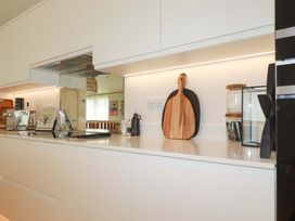 A kitchen with a countertop, cutting board, and kitchen appliances at 8 Karn Havos St. Eval near Mawgan Porth