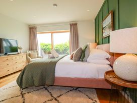 A bedroom with a bed and television at 8 Karn Havos in St. Eval near Mawgan Porth