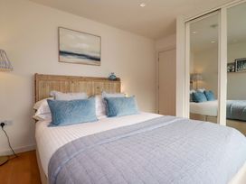 A bedroom with a bed and lamp at 8 Karn Havos St. Eval near Mawgan Porth